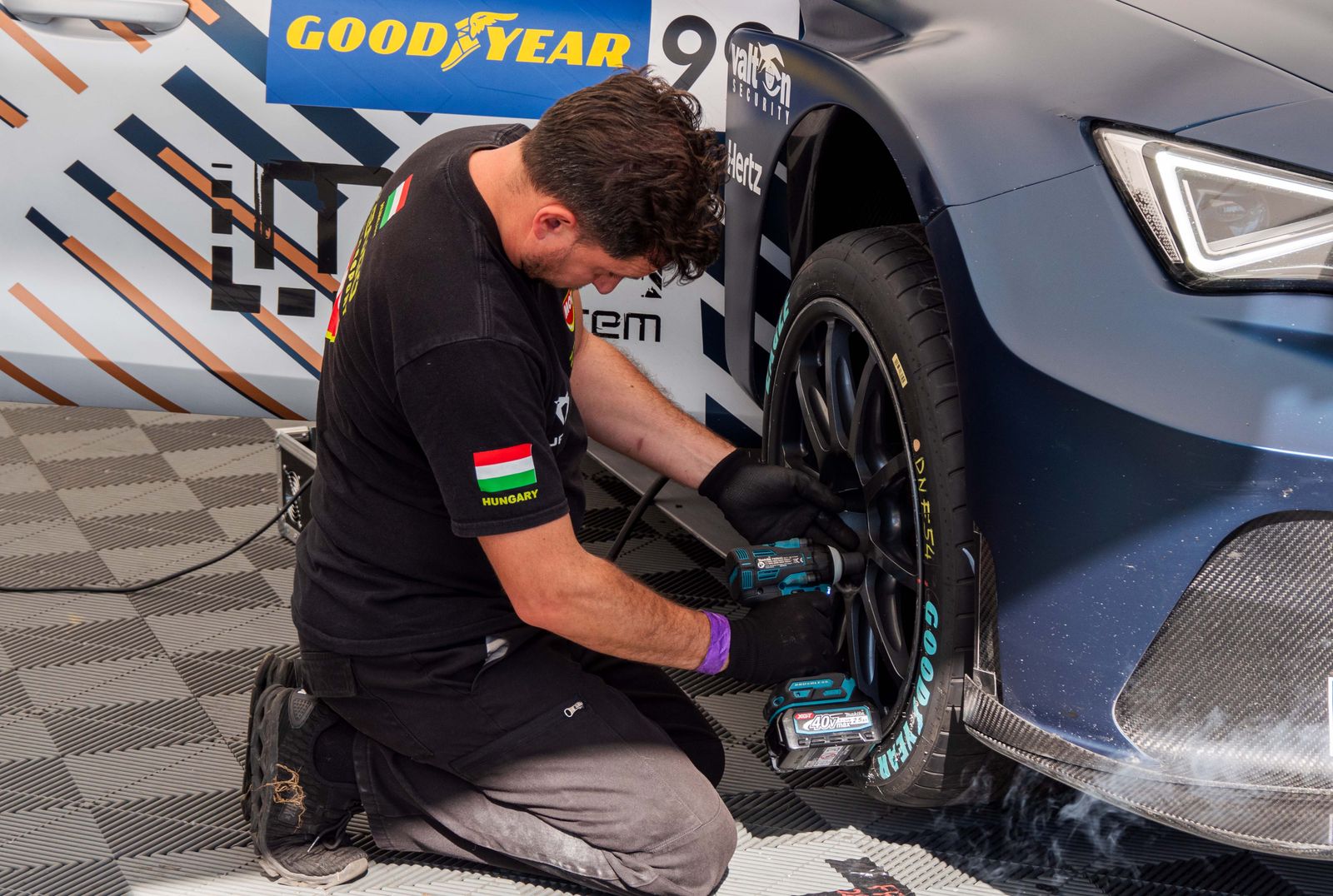 Mechanic working beside a vehicle wheel